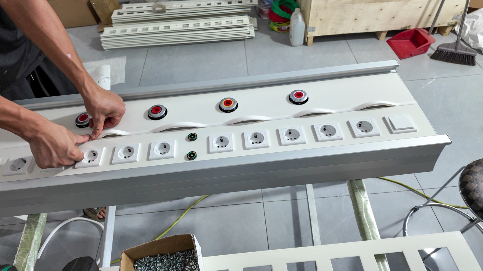 Fitting the socket modules and gas outlet surrounds into the panel.