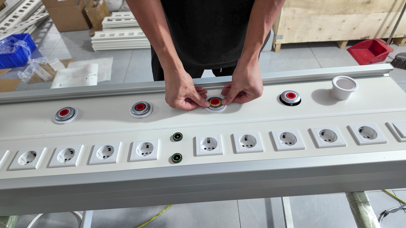 Setting a medical gas outlet into the panel beside the socket row.