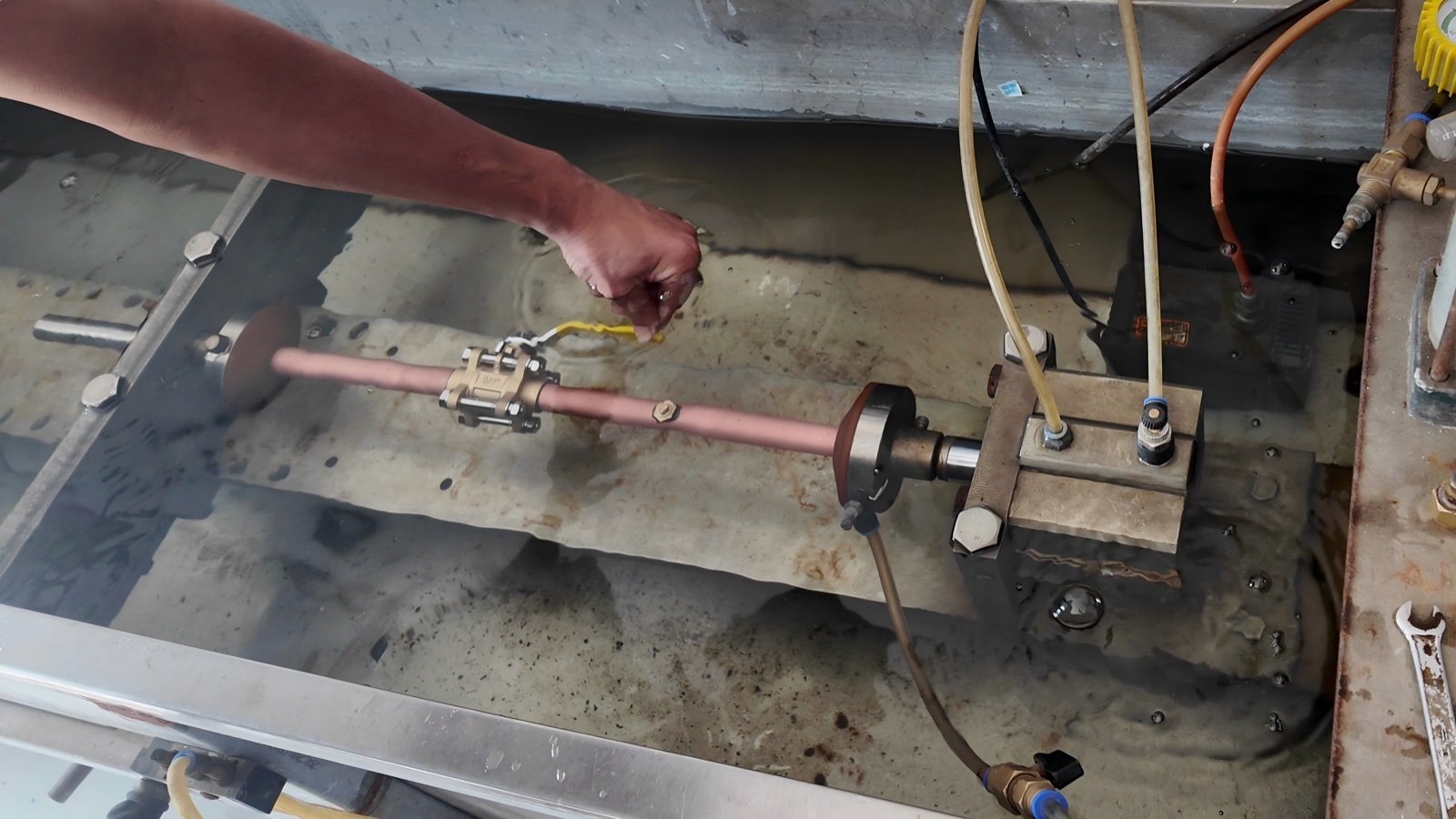 Gas-tightness check on the assembled copper pipe and valve section of the zone valve box.