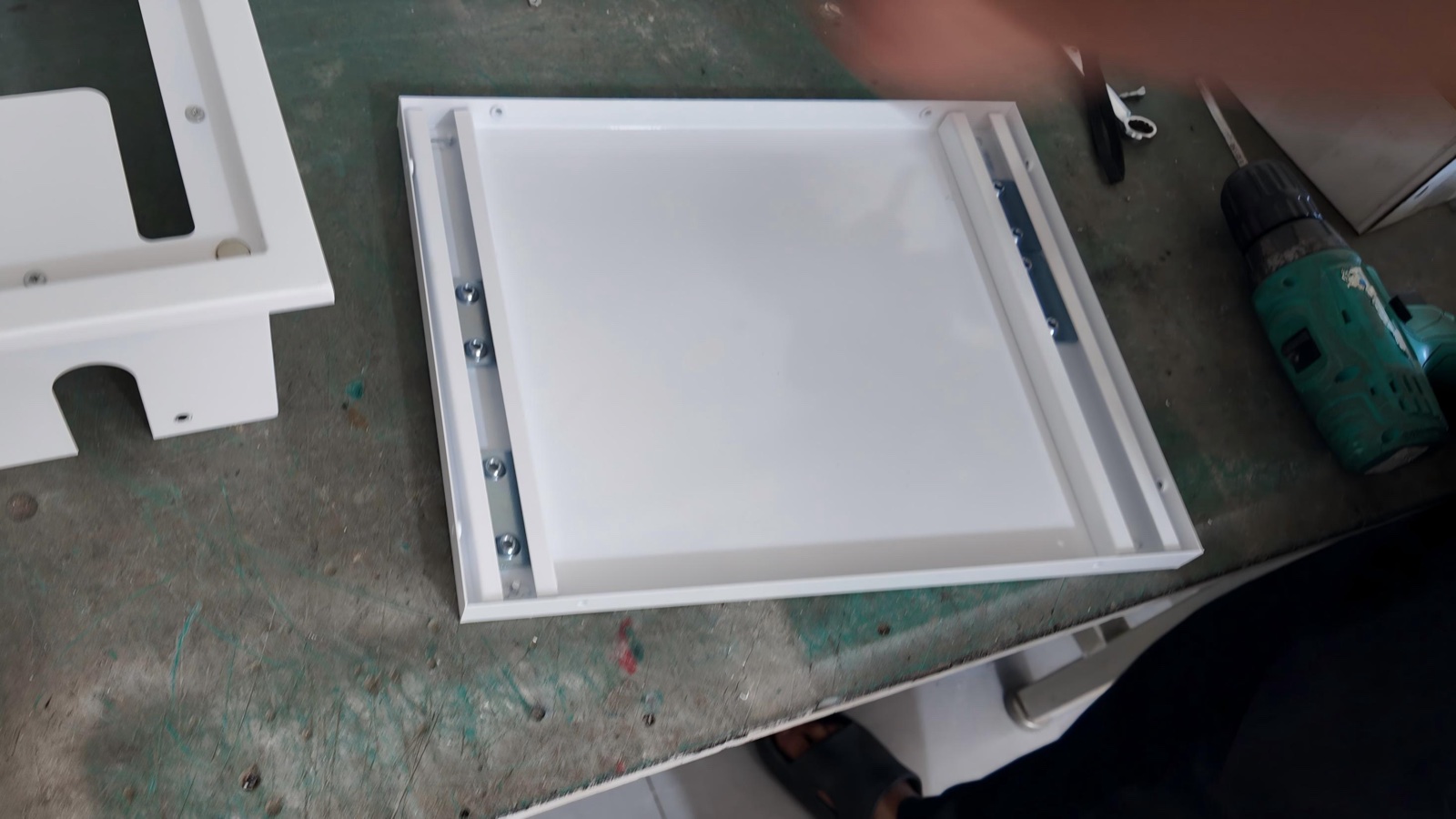 Assembling the box housing and inner panel frame on the workshop bench.