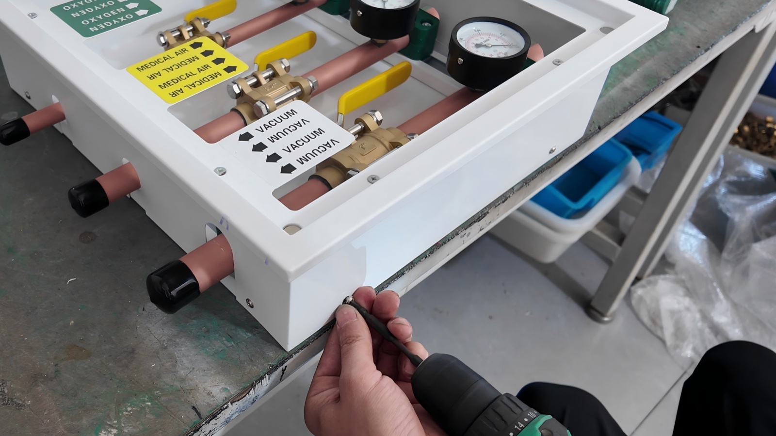 Gas identification plates for oxygen, medical air and vacuum, with the inlet and outlet pipes capped for protection.
