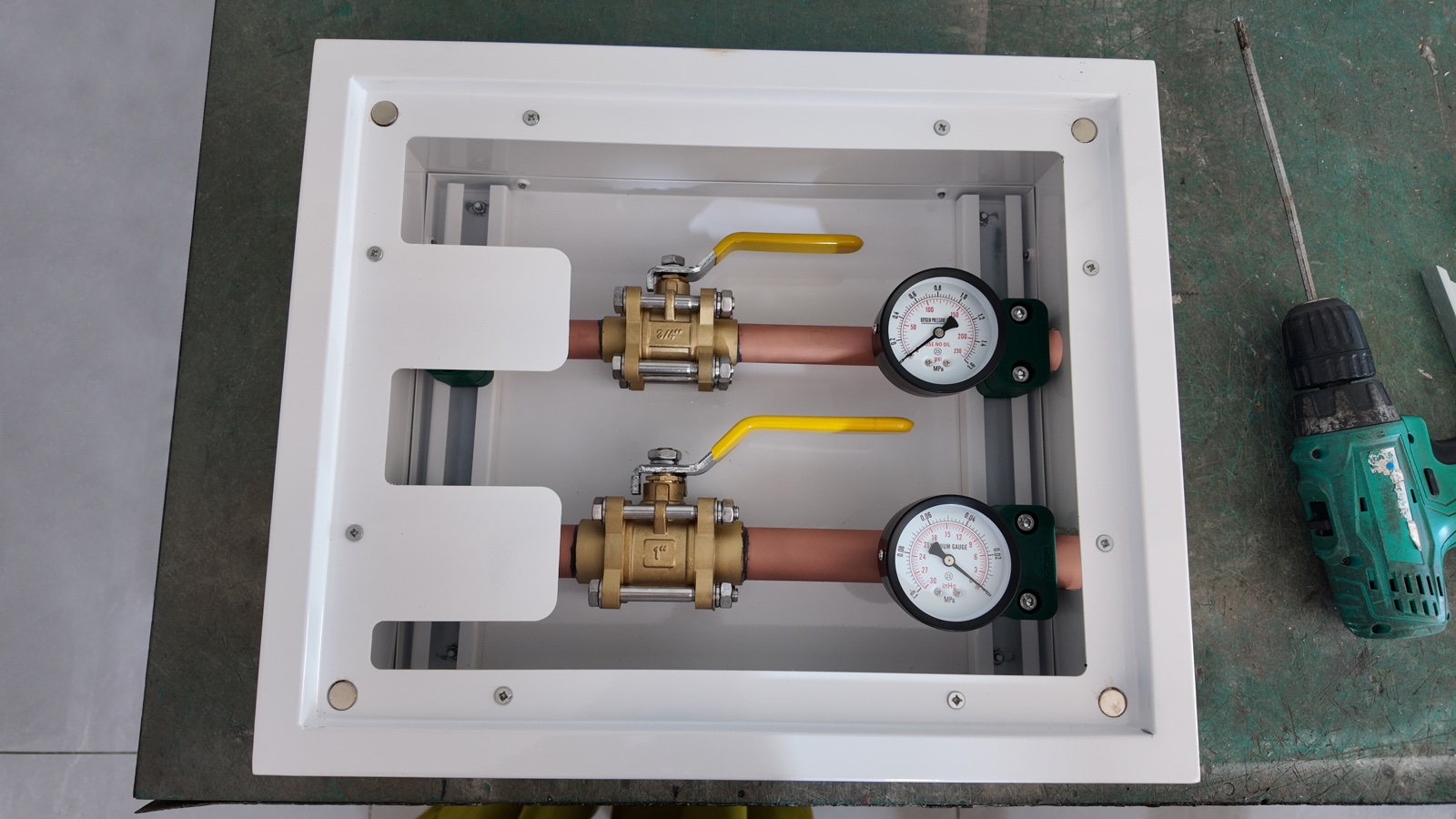 Completed interior with two gas lines, ball valves and pressure gauges.
