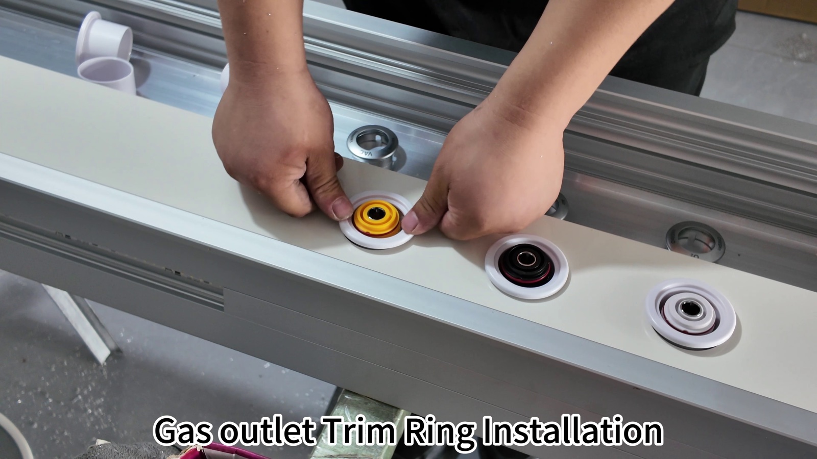 Pressing the trim ring onto a medical gas outlet.