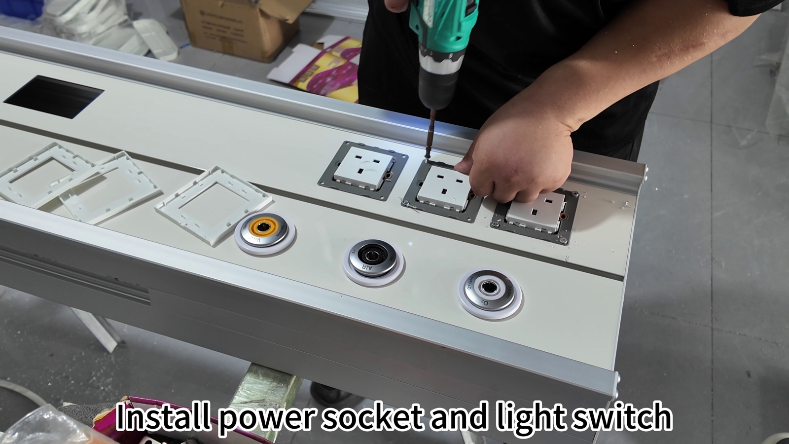 Securing power socket modules and a light switch into the panel.