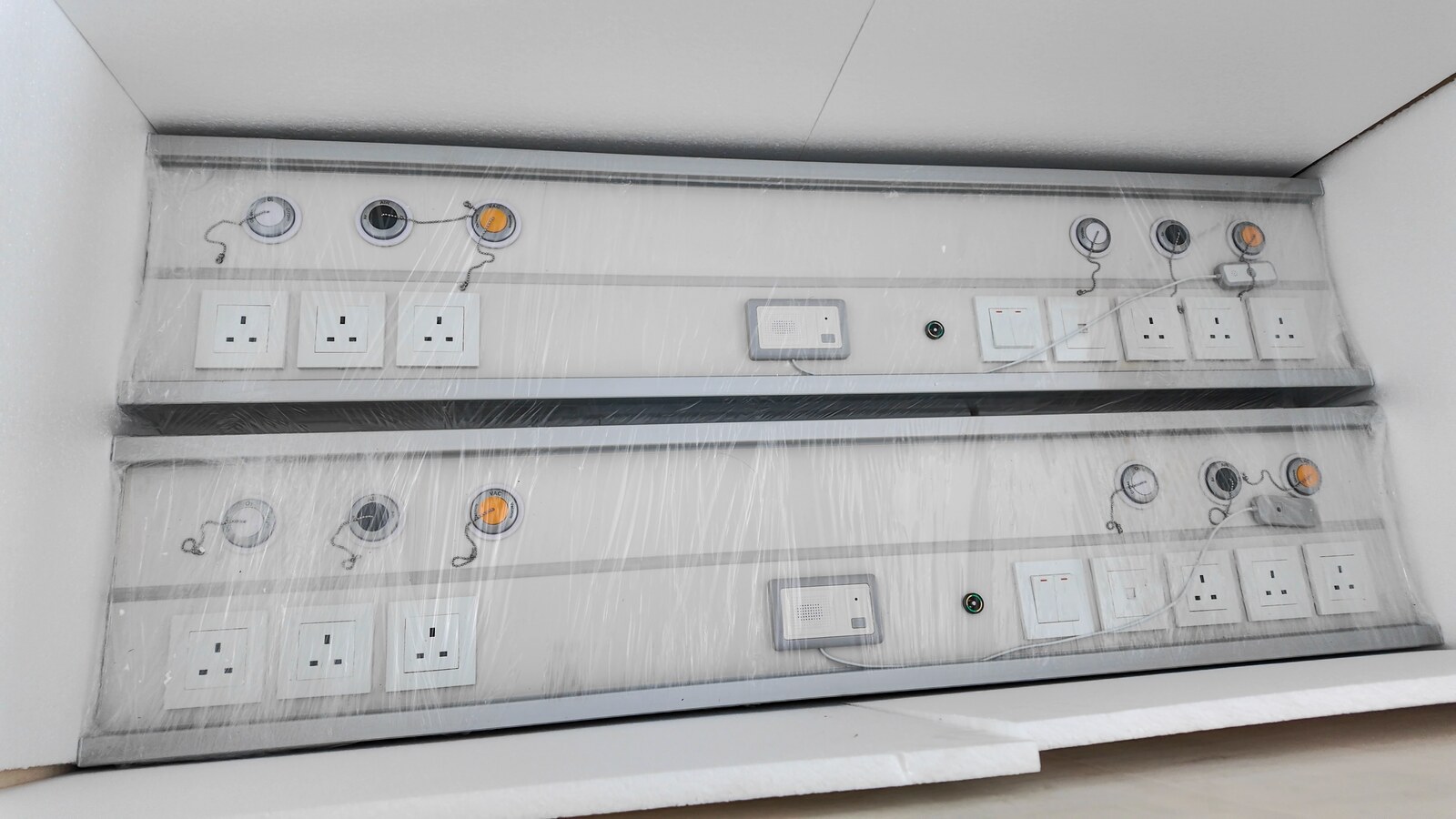Two finished units wrapped in protective film with foam lining.