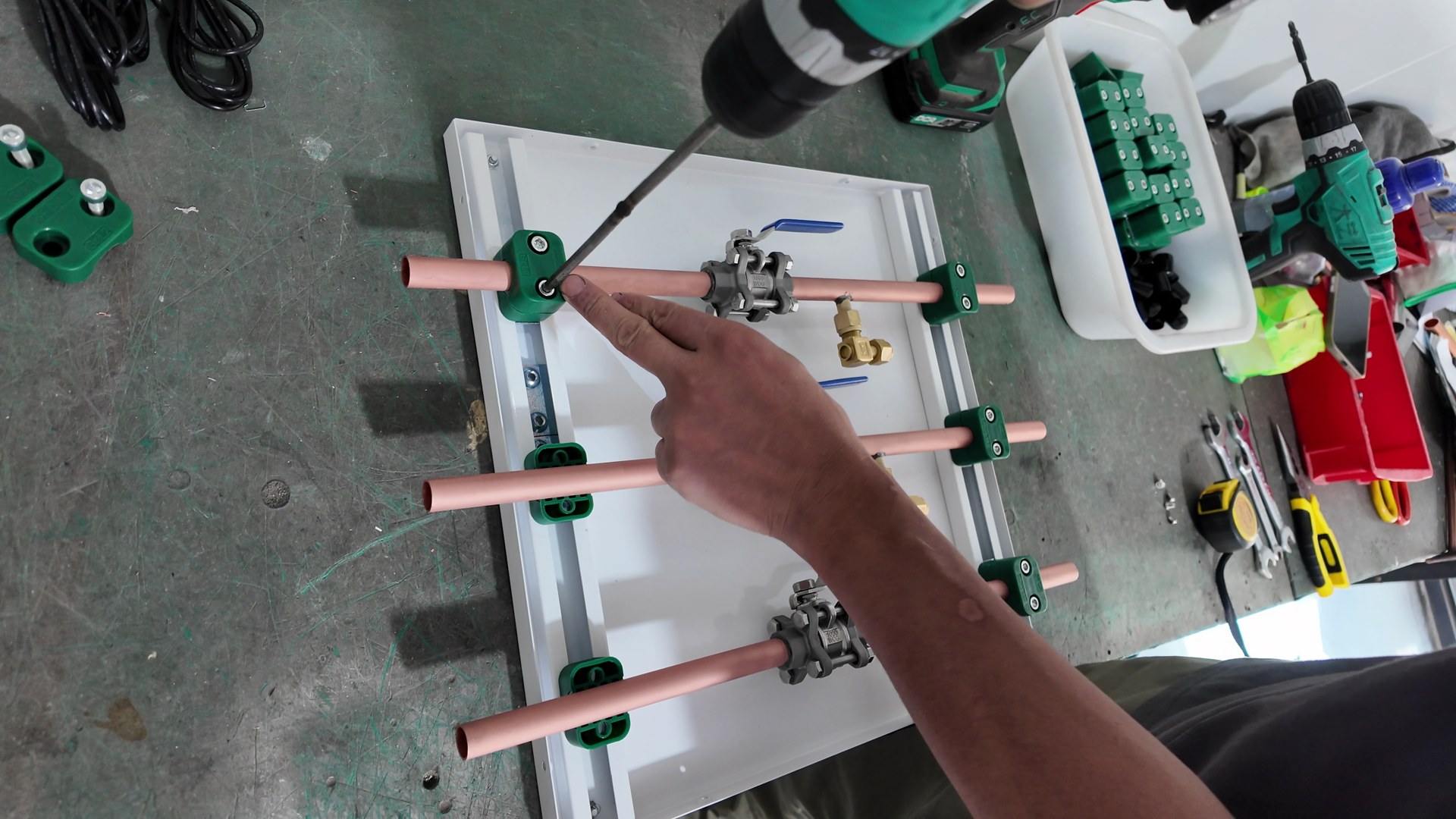 Securing three copper pipe and valve assemblies to the mounting panel